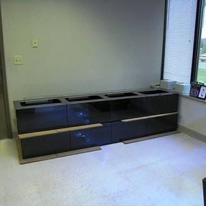 2 banks of 8' foot aquariums. They are each are divided into 4 sections. 80 gallons per bank.